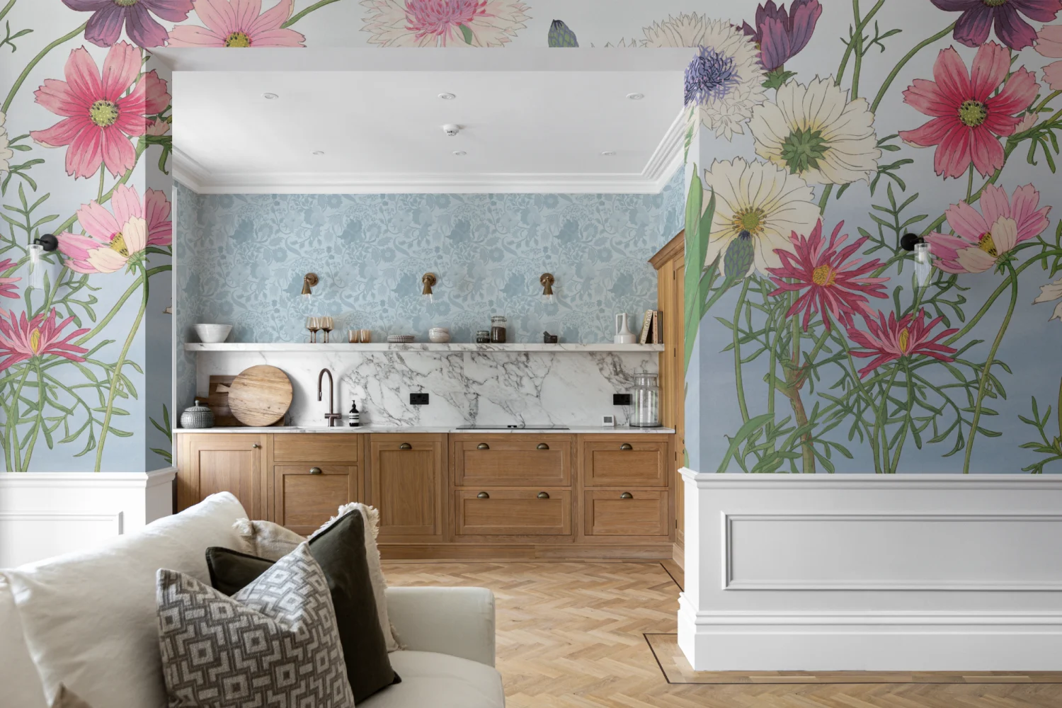 A kitchen with a floral mural featuring pink, white, and purple flowers on a blue background alongside natural wood cabinetry.