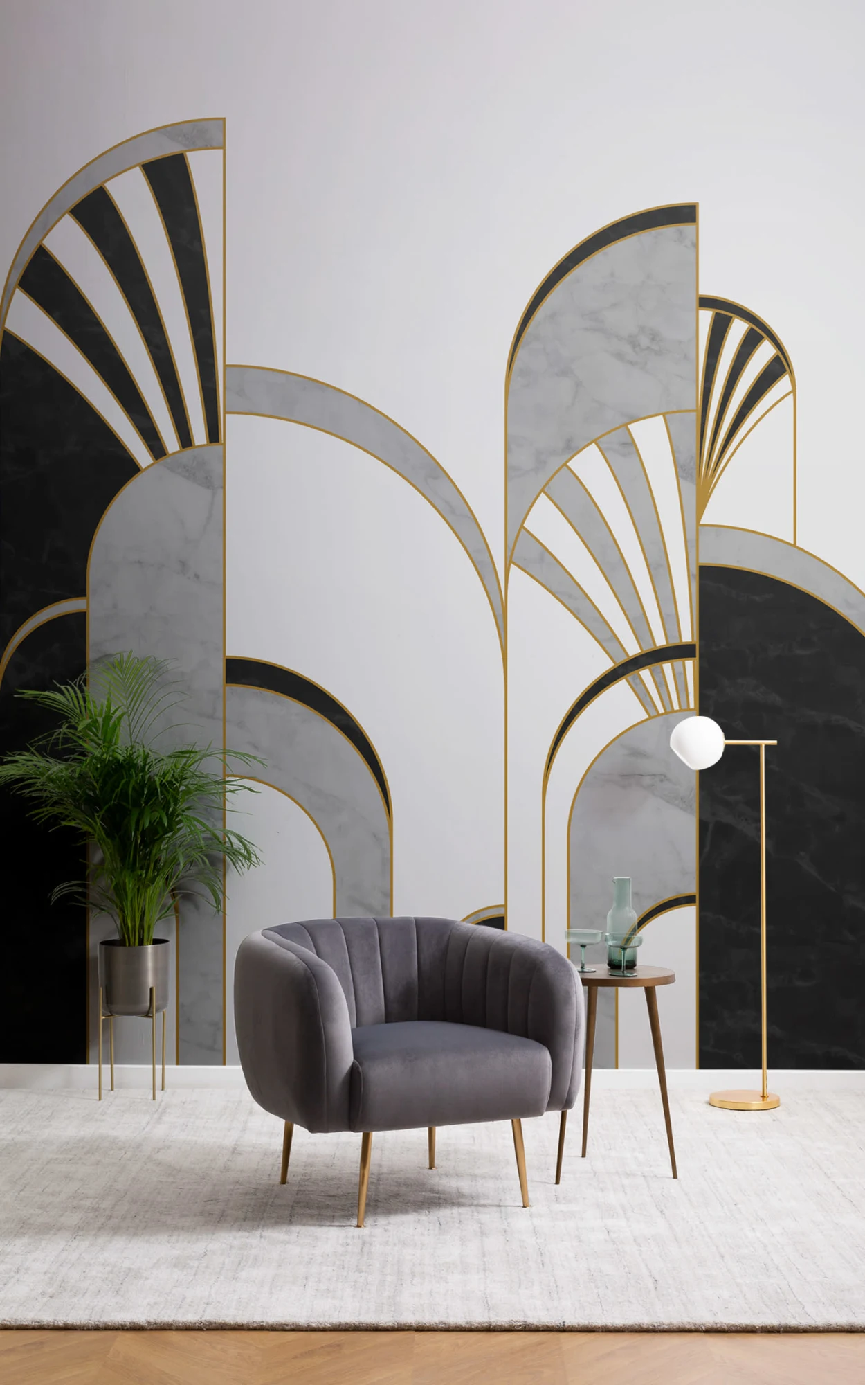 Elegant living area featuring Art Deco-style golden arches on marble panels. Includes a plush gray armchair, a small wooden side table with decorative items, and a minimalist gold floor lamp.