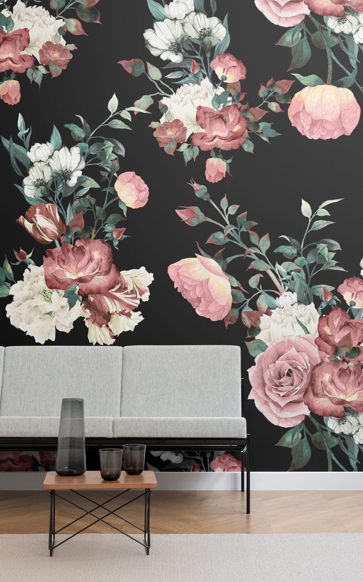 A minimalist living area with a large floral wallpaper in shades of pink, red, and white on a dark background.