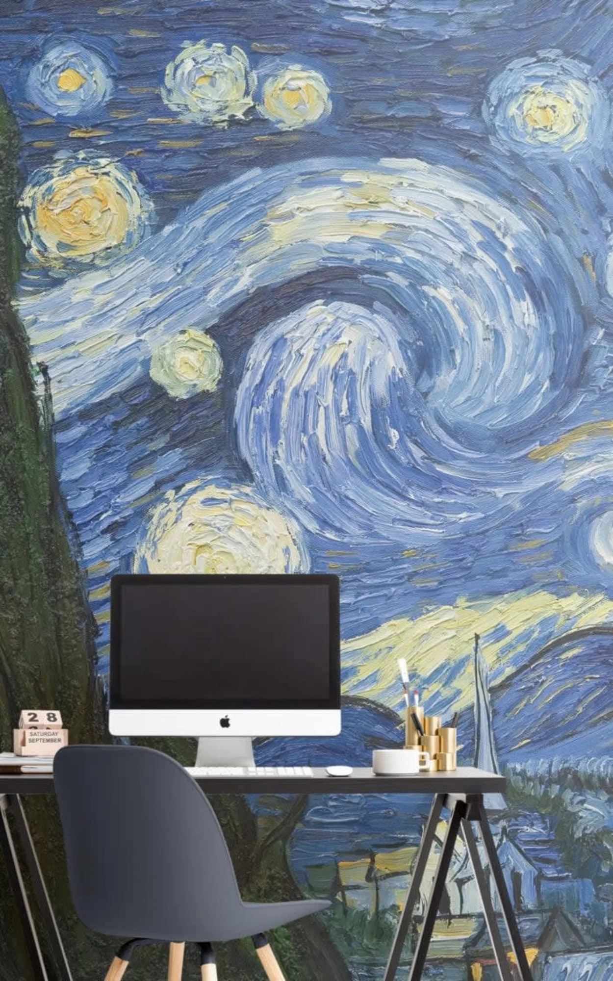  A creative workspace featuring a modern desk with an Apple computer, accompanied by a gray chair, set against a vibrant mural inspired by Van Gogh's "Starry Night," complete with swirling blues and bright yellow stars, creating an inspiring and artistic atmosphere for work or study.