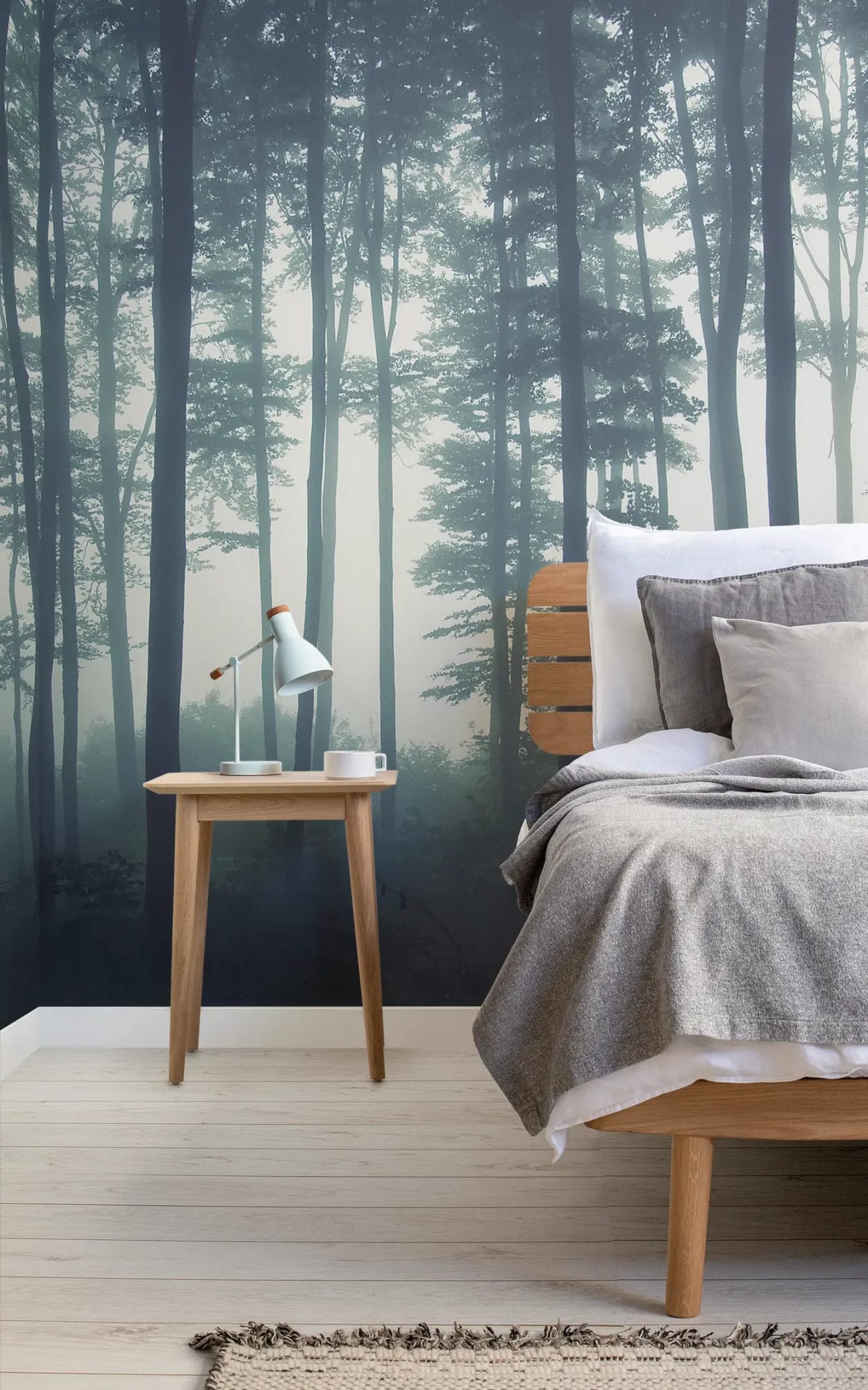 The bedroom features a soothing, large-scale mural of a misty forest, enhancing the calm and natural vibe of the space, perfect for relaxation.