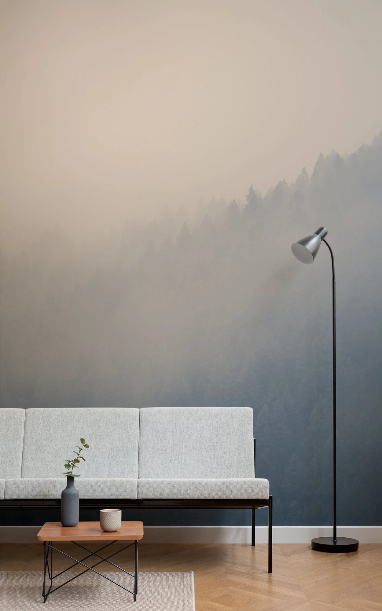 The living room is adorned with a misty forest wallpaper that brings a sense of tranquility and spaciousness to the modern, minimalist furnishings.