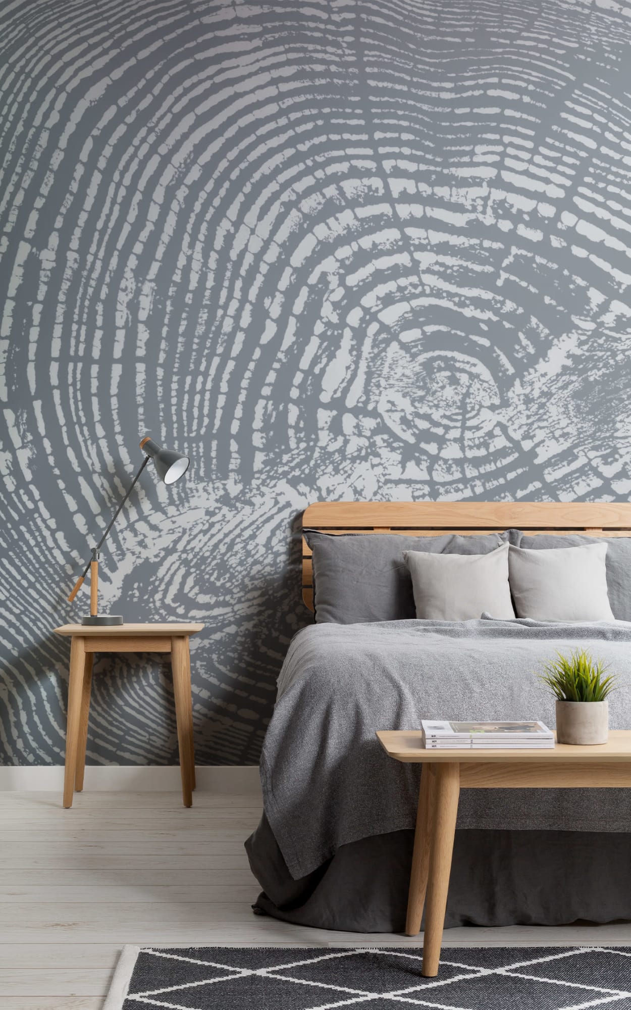Bedroom featuring a wood grain effect wall mural, wooden furniture, and gray bedding.
