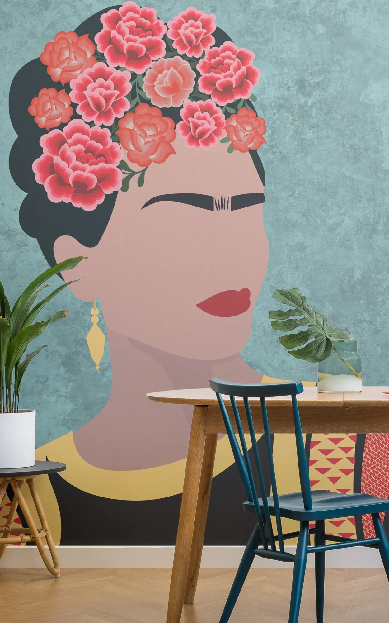 A stylized mural of a woman with a crown of pink roses, wearing a gold earring and a yellow necklace, depicted against a textured turquoise wall, accompanied by modern furniture and indoor plants.