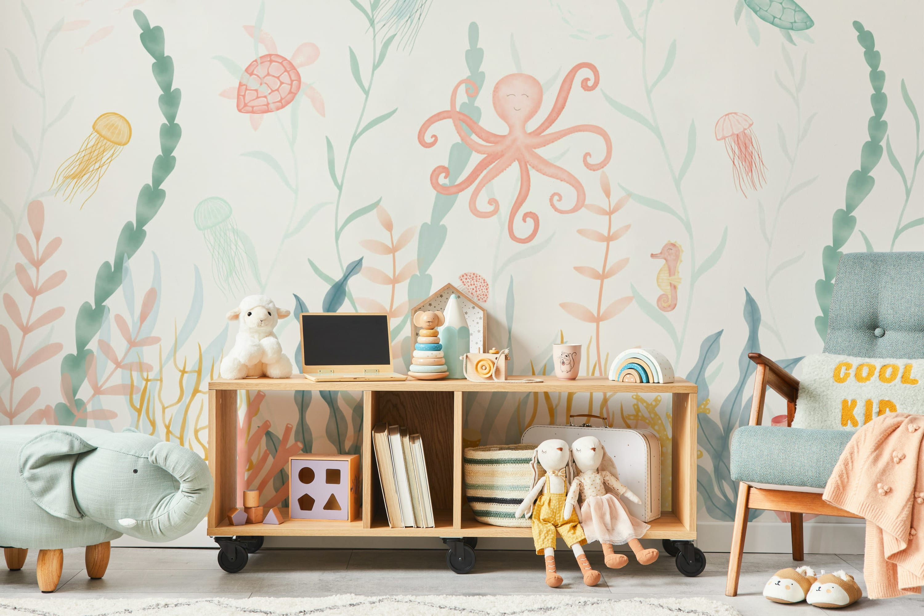 An underwater-themed nursery with a mural of sea animals like an octopus, jellyfish, and seahorse.