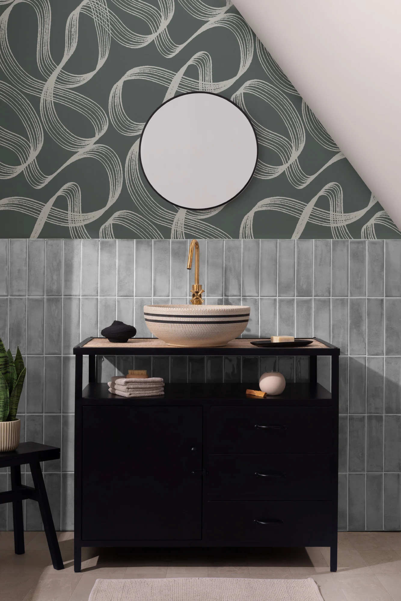 A Japandi bathroom with teal swoop-patterned wallpaper, black vanity, and gold faucet.