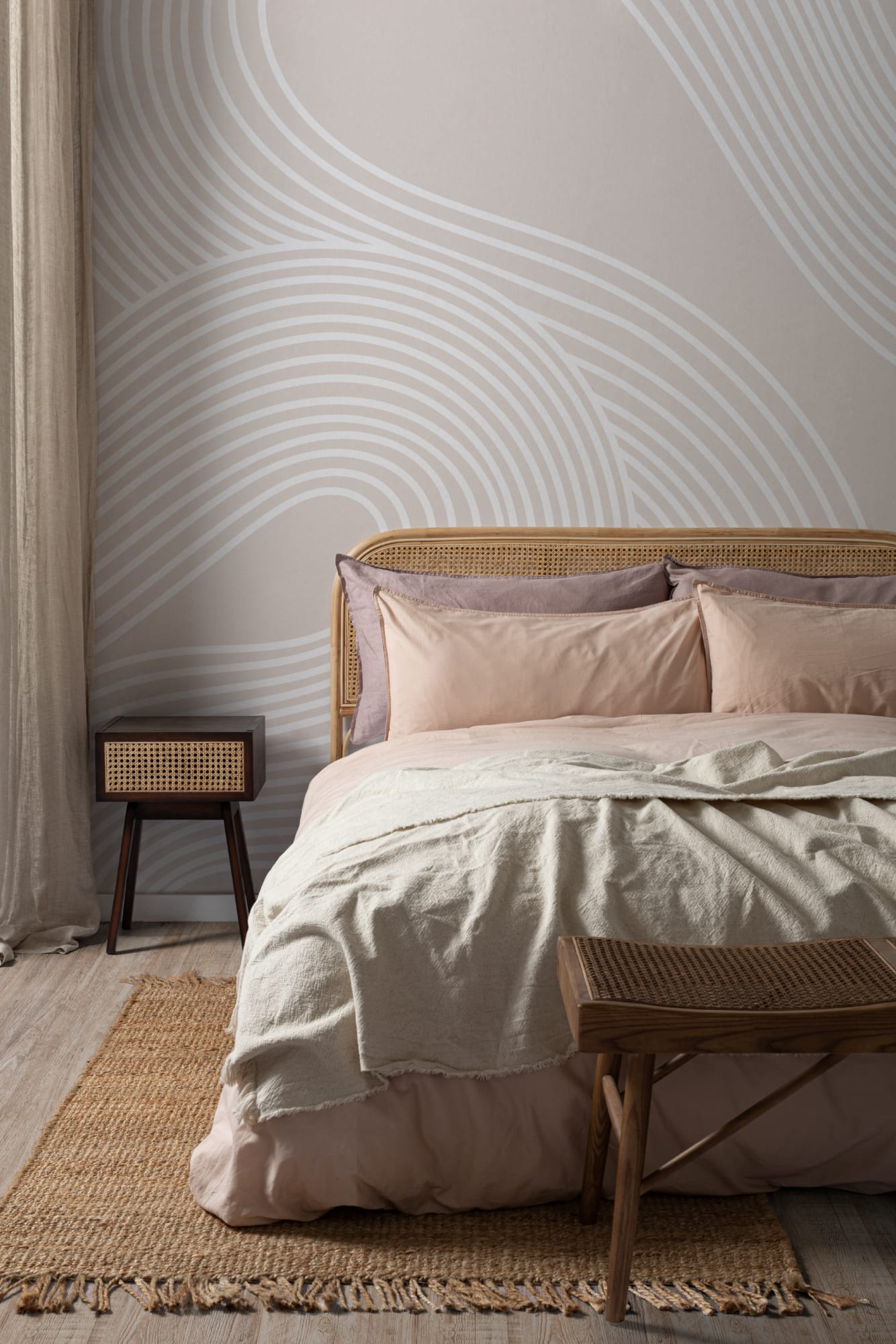 A neutral-toned minimalist bedroom with a Zen-inspired linear mural, woven furniture, and cozy textures.