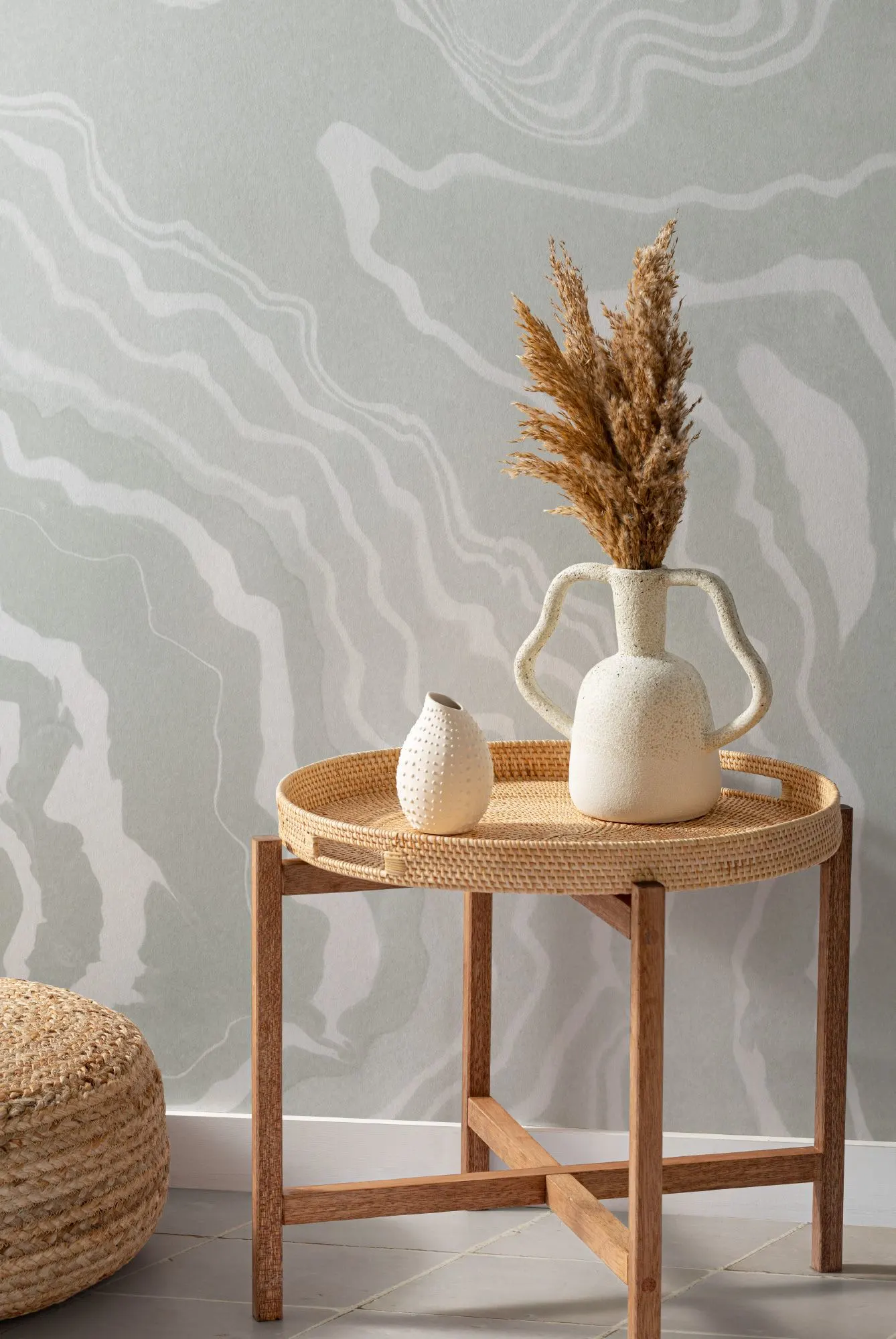 A calming room with a green Japandi style mural, a rattan tray, and minimalist decor.