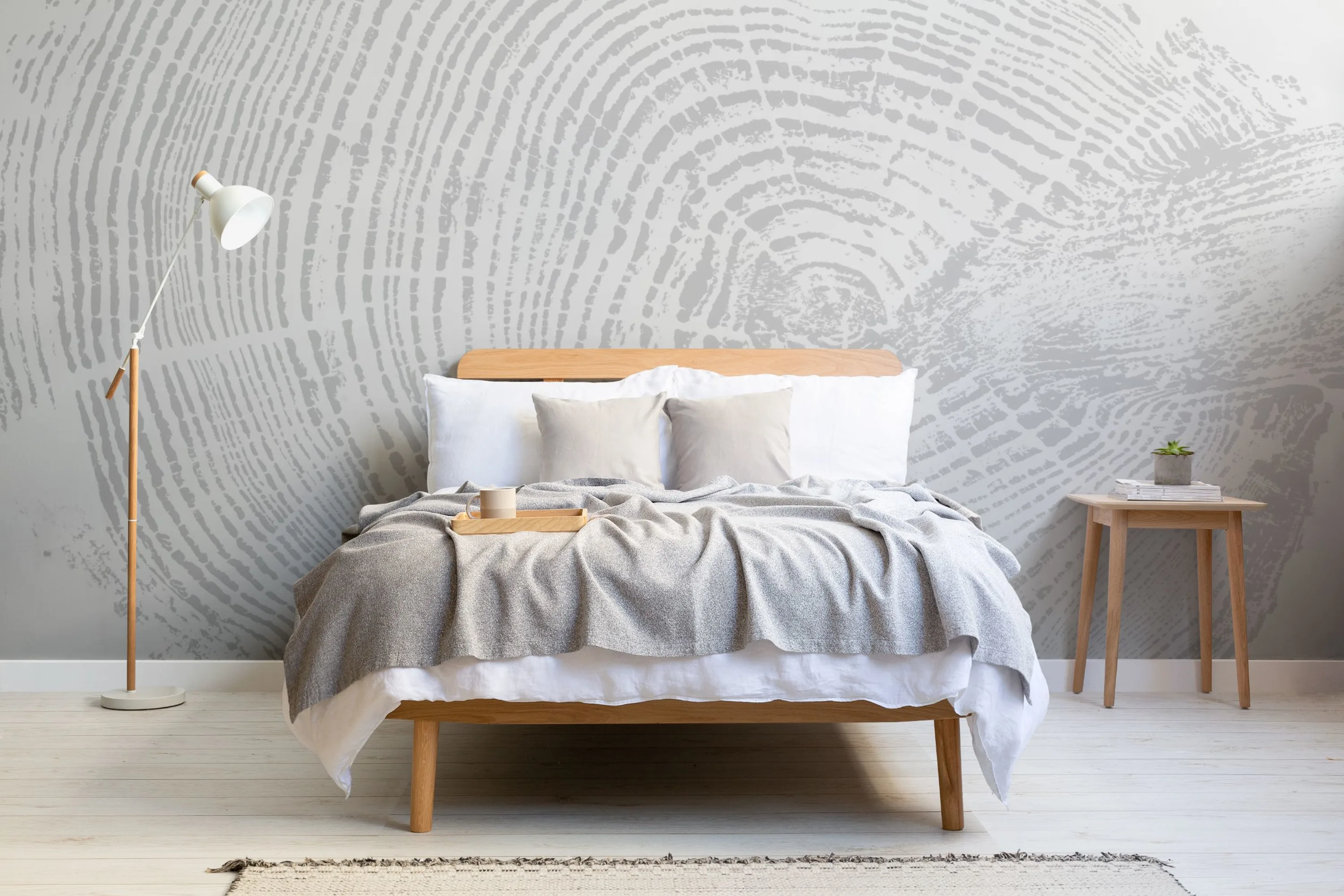 A calm Scandi style bedroom with a light gray wood grain style mural, neutral bedding, and simple wooden furniture.