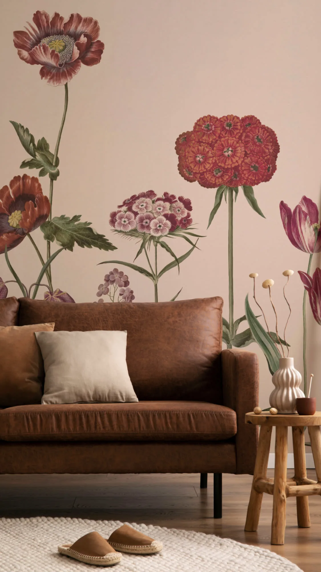 A living room with a large wildflower mural and a rustic wooden side table beside a brown sofa.