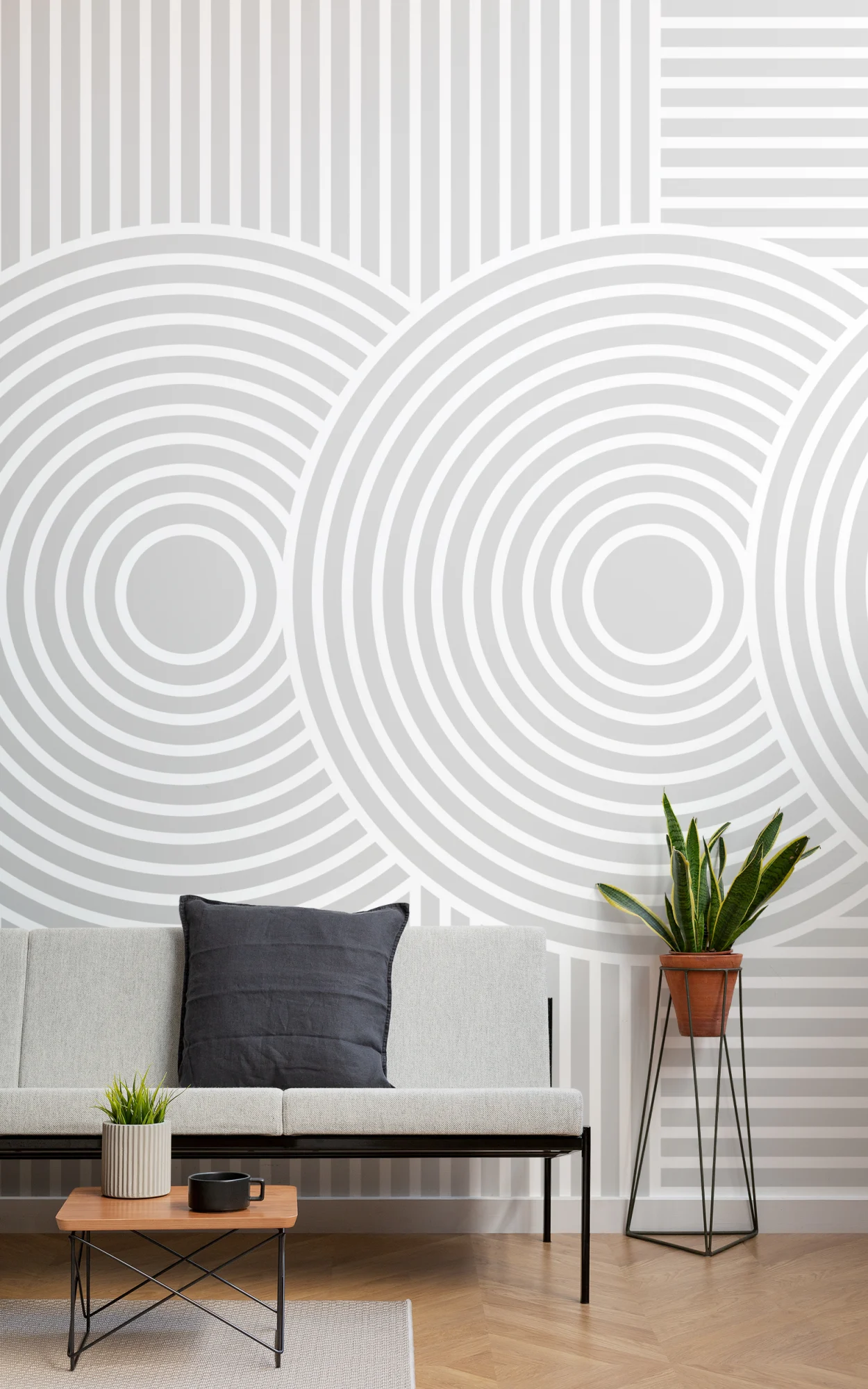 A geometric grey and white wallpaper with circular and linear patterns in a modern, minimalist living space.