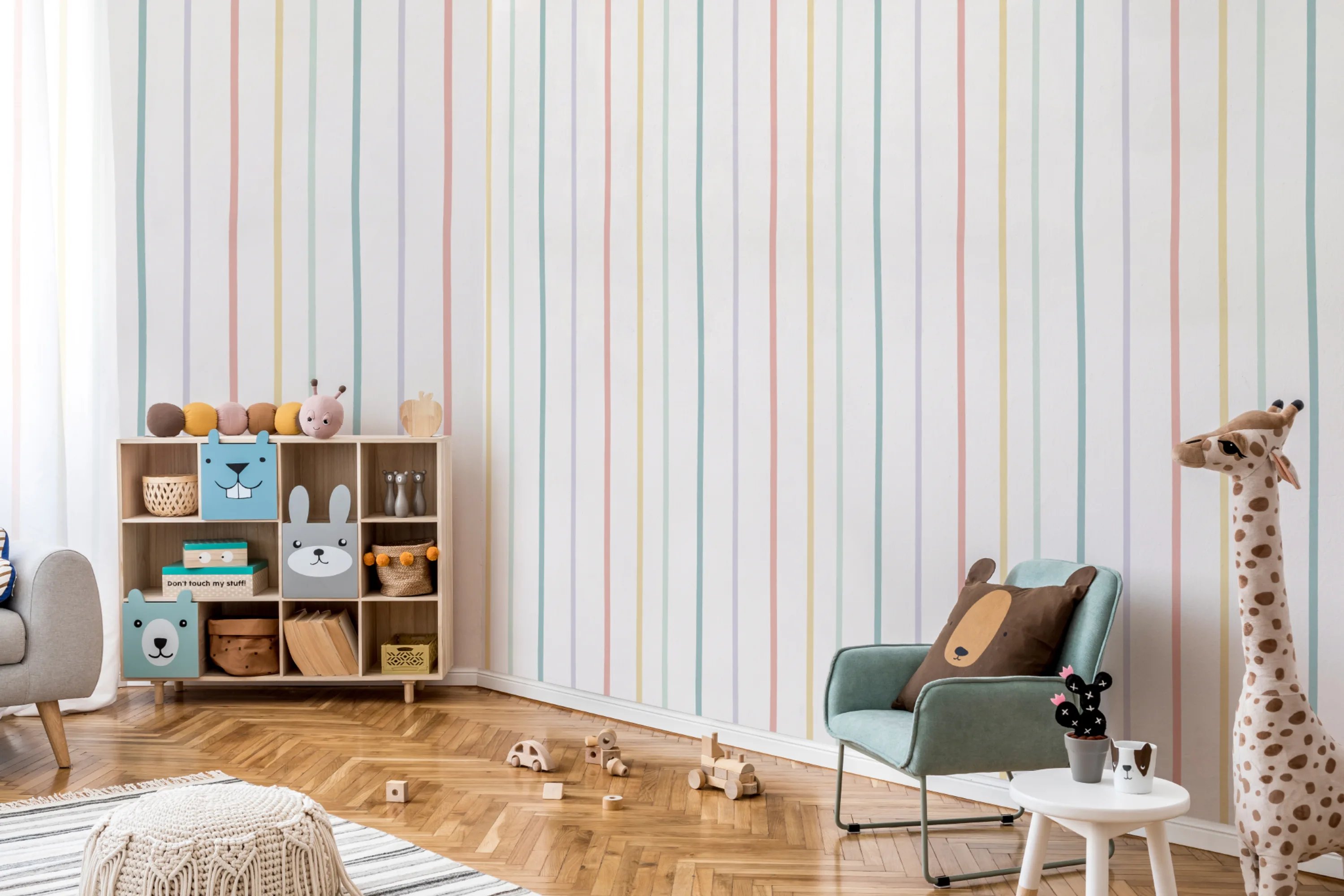 A cheerful playroom with vertical pastel stripes on the wall, wooden toys, and a cozy reading nook.