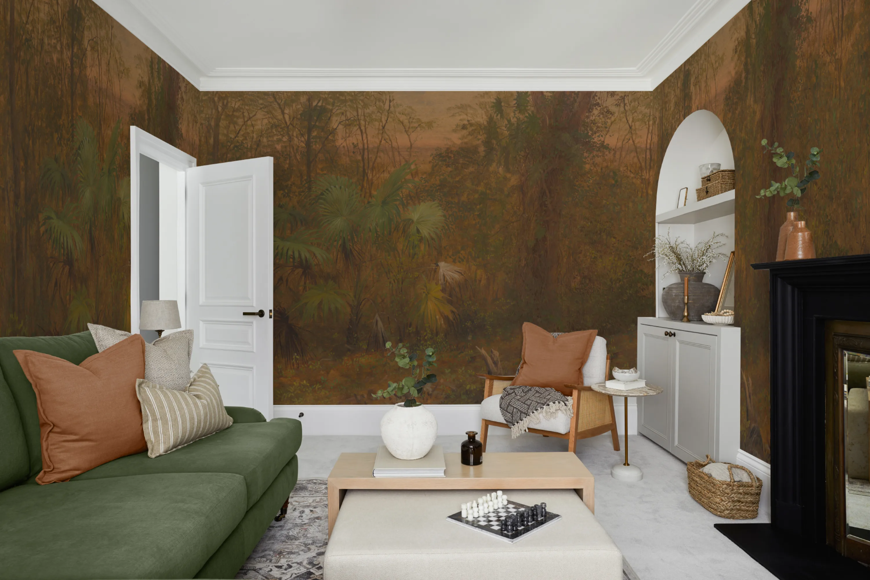 Cozy living room featuring a green sofa and earthy decor with a rich jungle mural in warm brown and green tones.