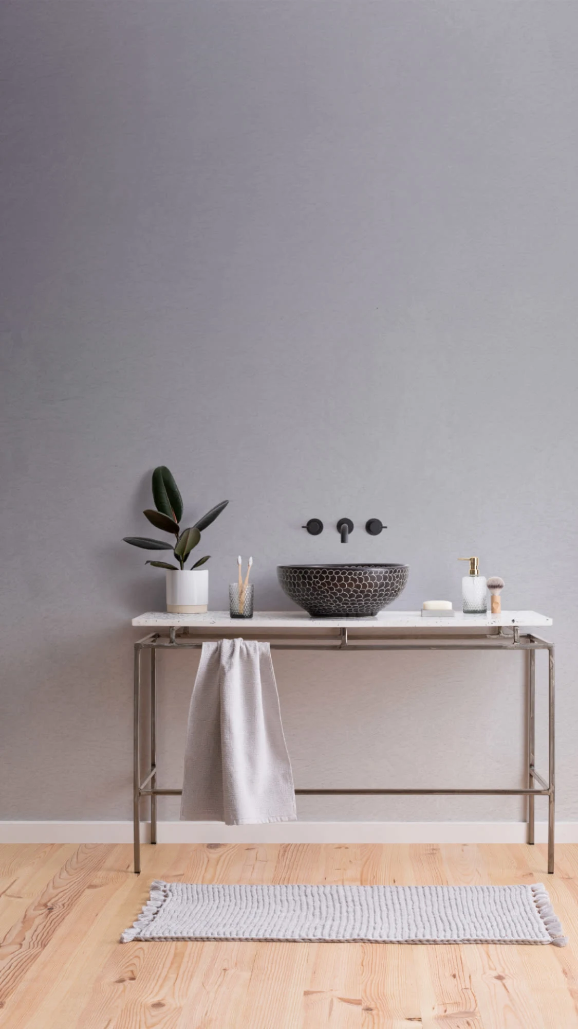 A soft gray ombré wallpaper in a serene bathroom with a floating marble sink and minimalist black fixtures.