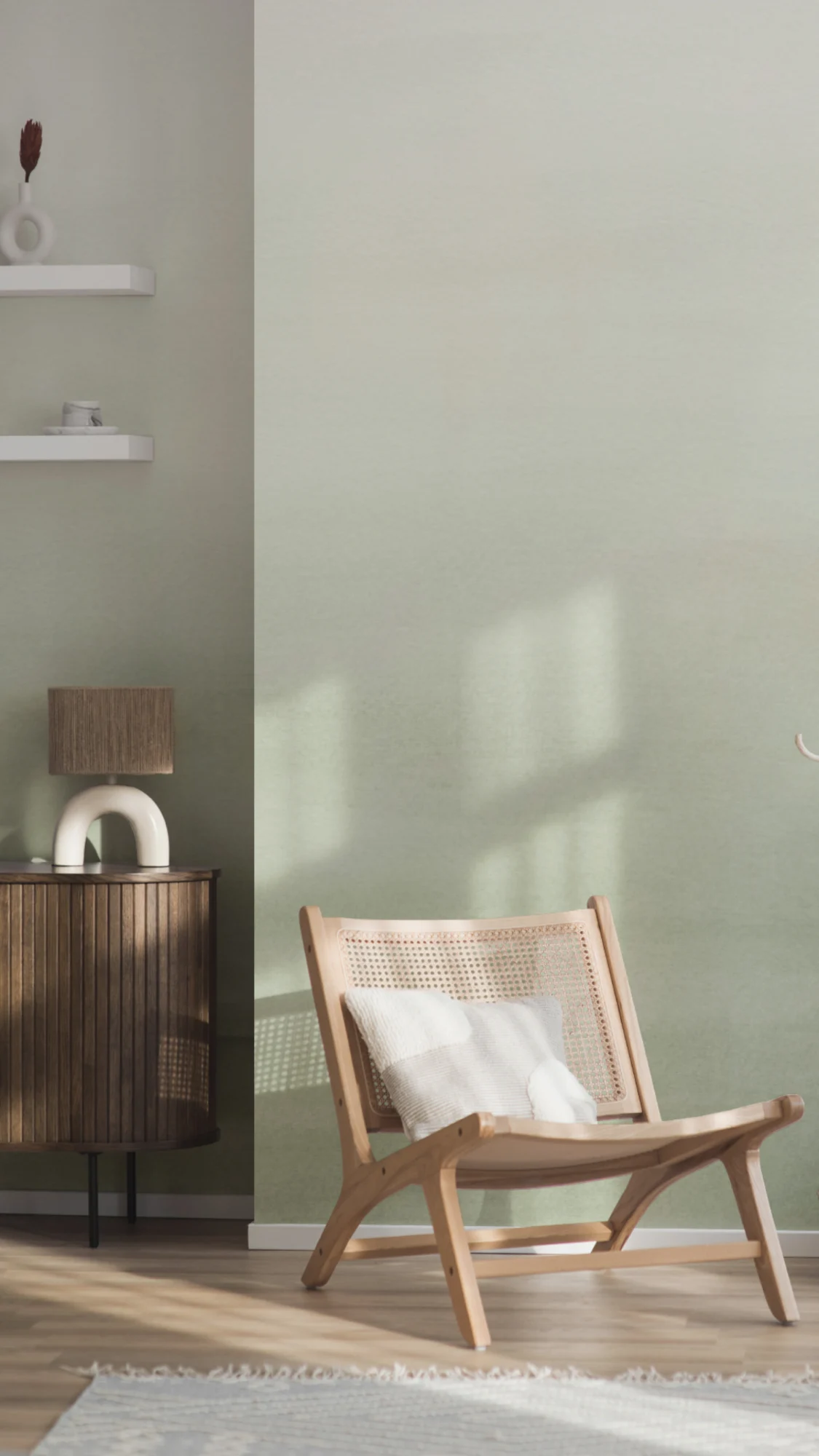 A calming green ombré wallpaper in a light-filled room with a wooden lounge chair and simple furnishings.