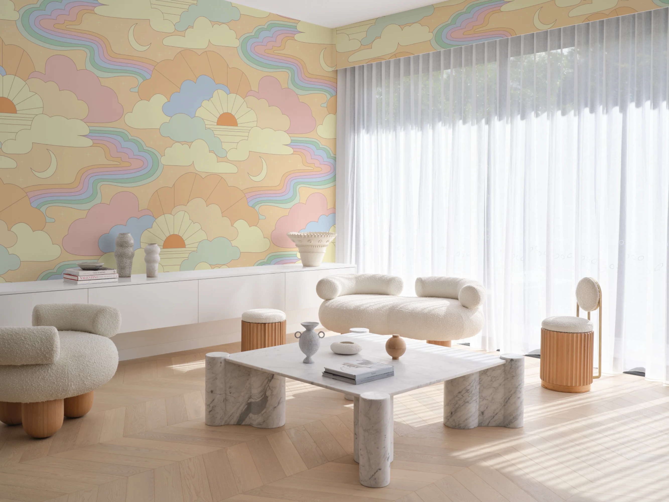 Bright living room with pastel mural of clouds, rainbows, and sunbursts behind white modern furniture.