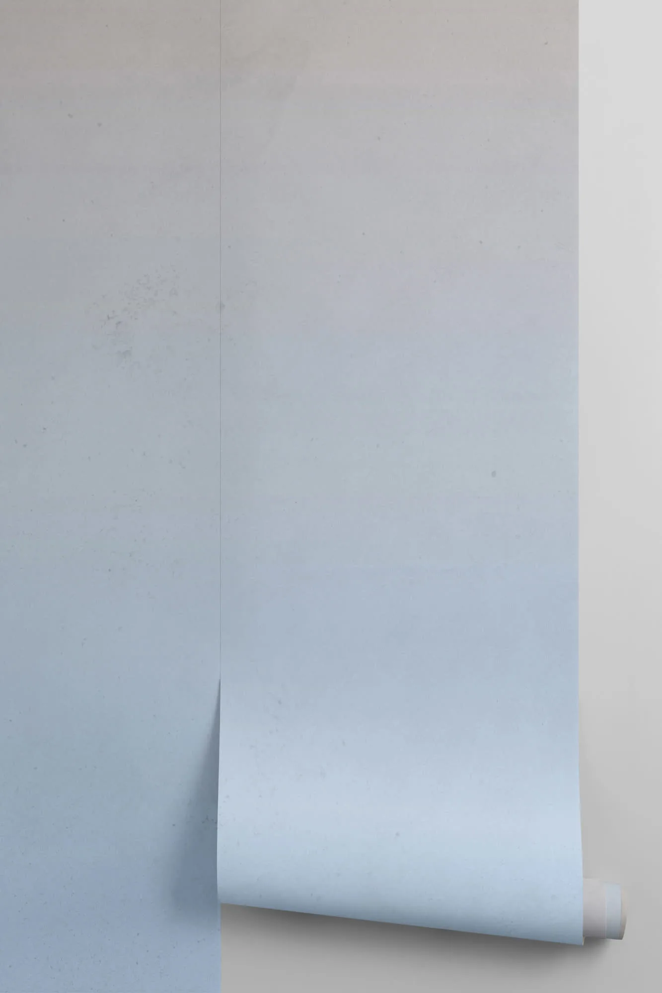 Wallpaper roll featuring a soft gradient ombre in cool grayish blue tones.