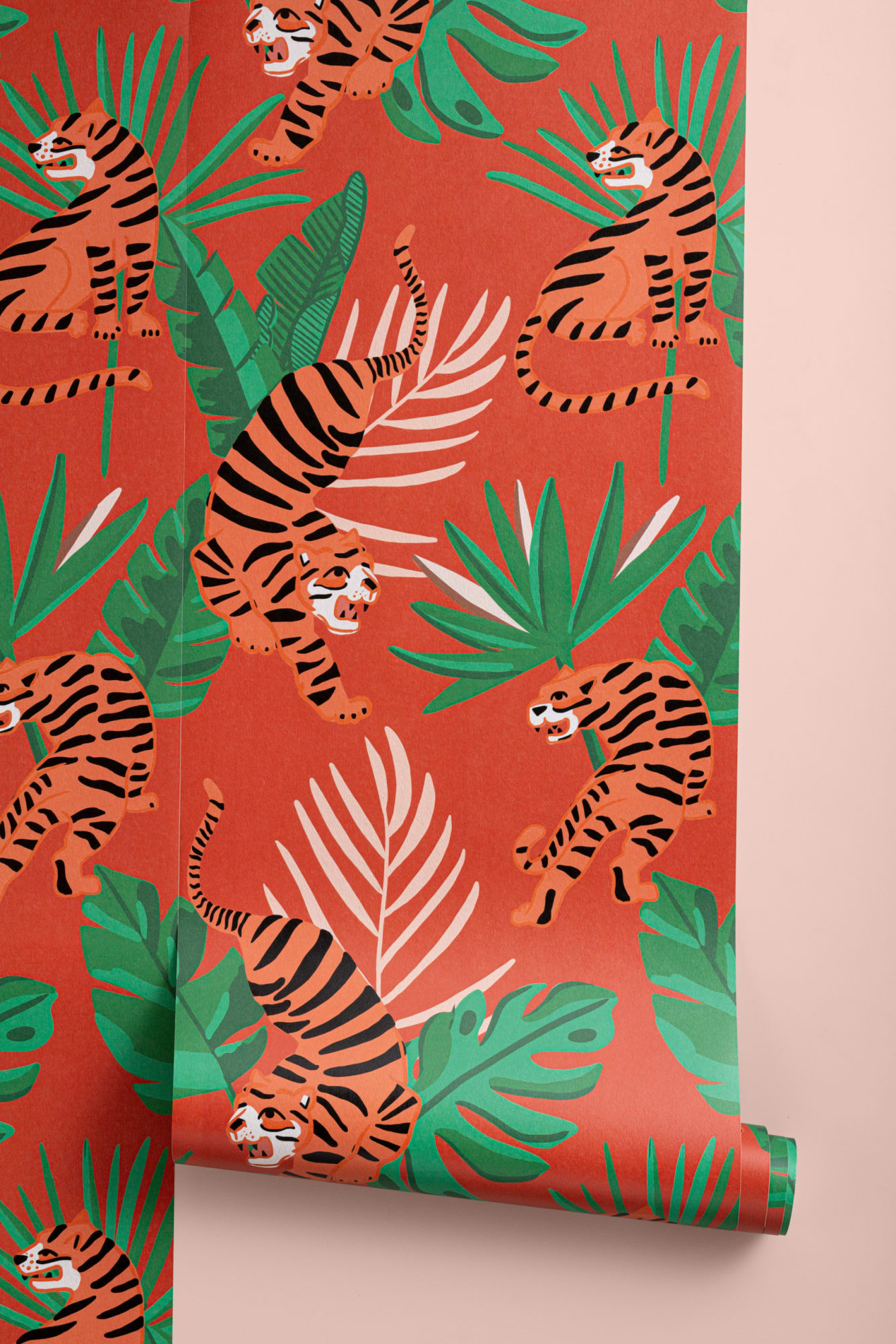 Red wallpaper with illustrated tigers and jungle leaves in green, rolled and displayed vertically.