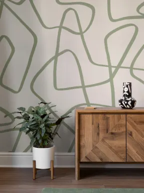 Mural de parede com rabiscos abstractos desenhados à mão em verde sobre fundo neutro